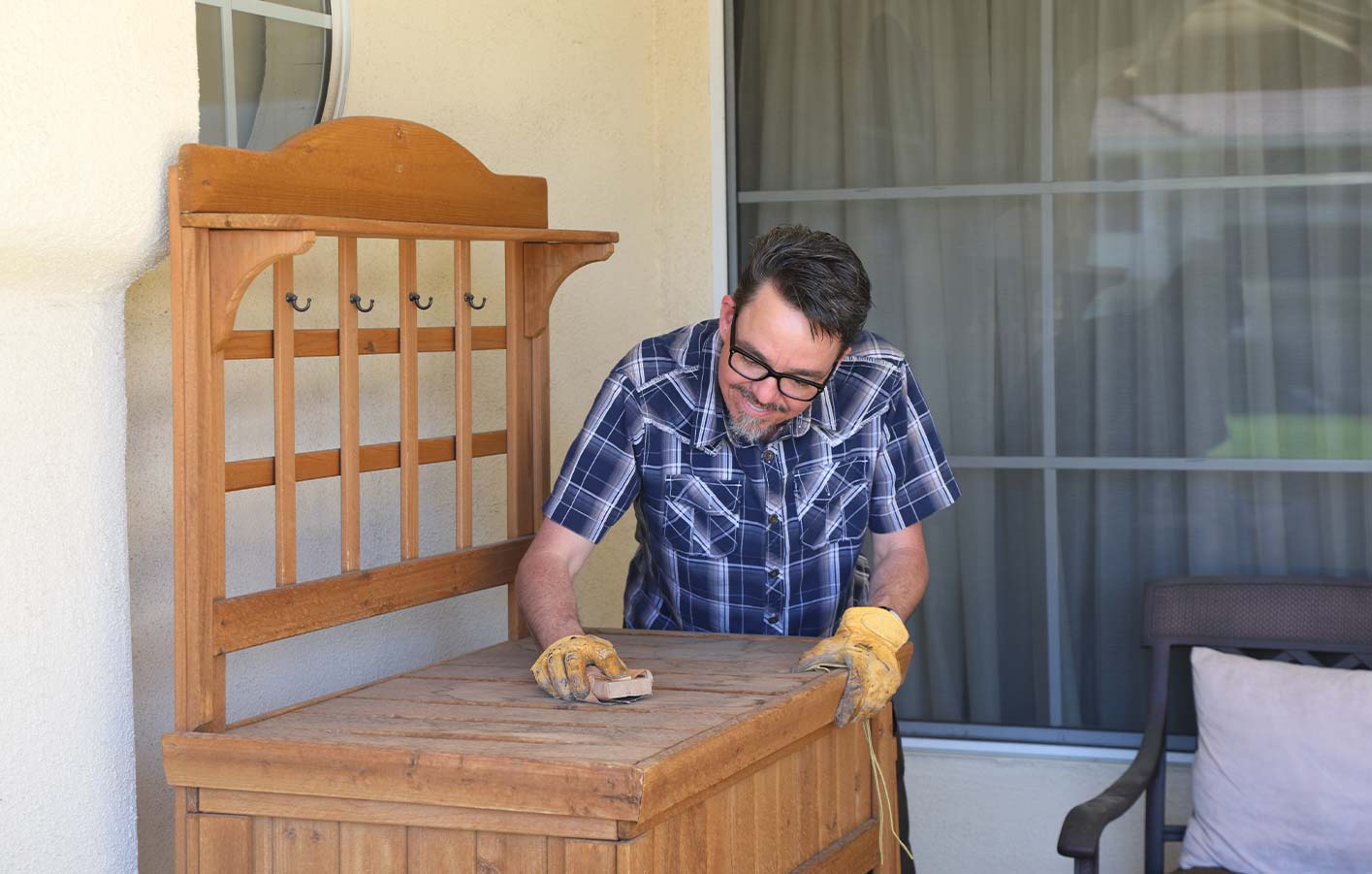 Mann restauriert altes Holzmöbelstück